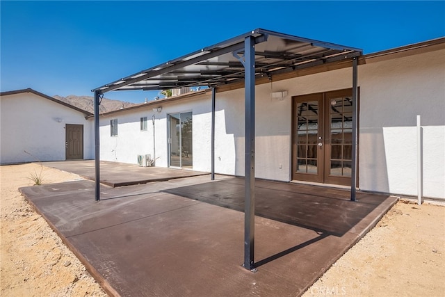 73570 Cedar Dr Unit 29, Palms, CA 92277 - rear view of property with french doors, stucco siding, and a patio