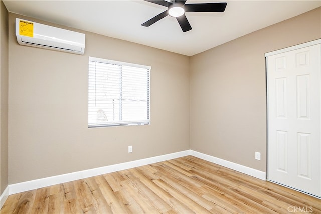 73570 Cedar Dr Unit 29, Palms, CA 92277 - unfurnished bedroom with an AC wall unit, wood finished floors, a closet, and a ceiling fan