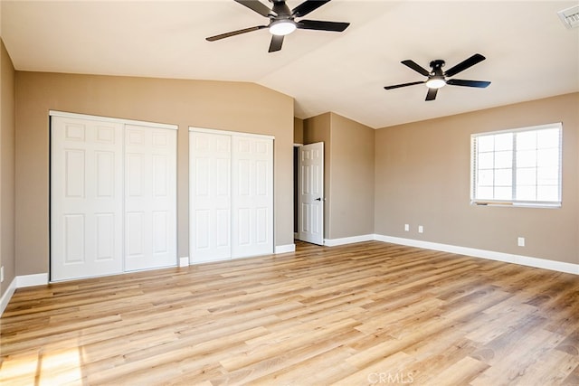 73570 Cedar Dr Unit 29, Palms, CA 92277 - unfurnished bedroom featuring multiple closets, light wood-style floors, vaulted ceiling, and a ceiling fan