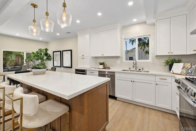 5461 Waring Rd, San Diego, CA 92120 - kitchen with stainless steel appliances, recessed lighting, decorative backsplash, a center island, and light wood-style floors