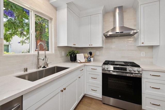 5461 Waring Rd, San Diego, CA 92120 - kitchen with wall chimney range hood, stainless steel gas stove, tasteful backsplash, and white cabinets
