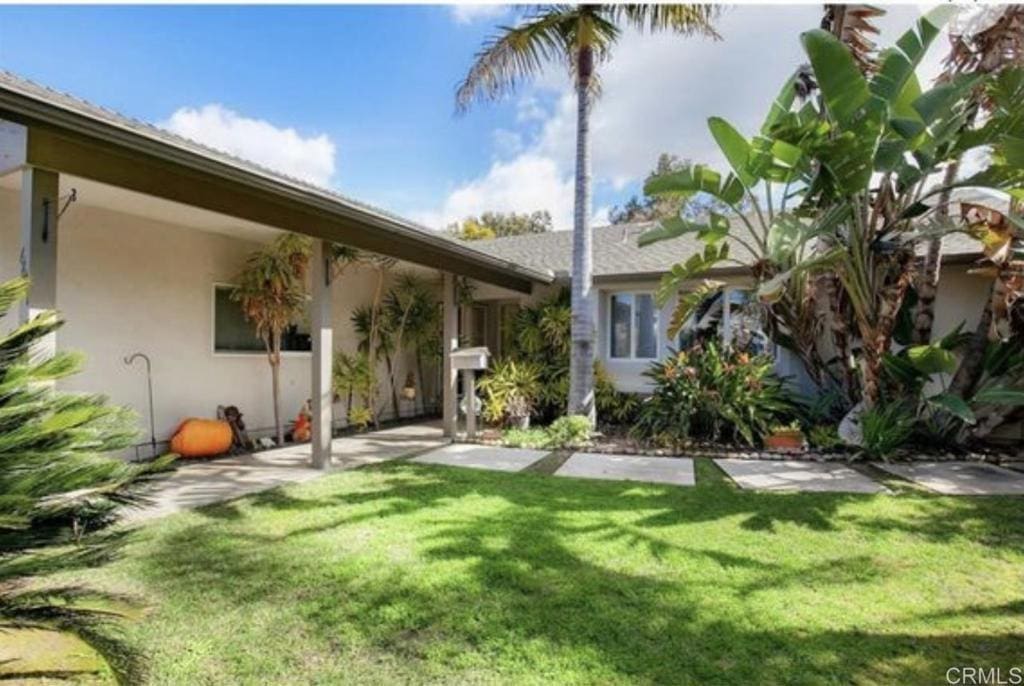 6667 Merwell St, San Diego, CA 92122 - rear view of house featuring a yard and stucco siding