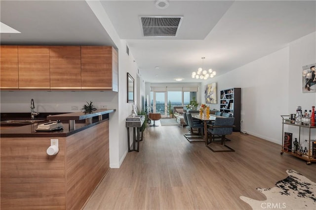 3785 Wilshire Blvd Unit 1605, Los Angeles, CA 90010 - dining area featuring a chandelier and light wood-style flooring
