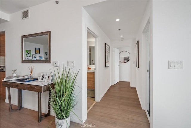 3785 Wilshire Blvd Unit 1605, Los Angeles, CA 90010 - corridor with light wood finished floors, recessed lighting, and a desk