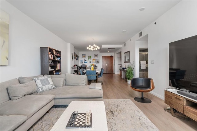 3785 Wilshire Blvd Unit 1605, Los Angeles, CA 90010 - living room featuring a chandelier and light wood-style flooring