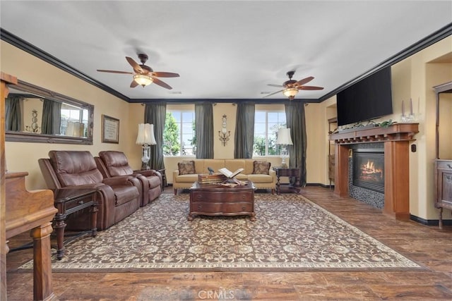 10705 Topiary Dr, Bakersfield, CA 93306 - living area with a ceiling fan, crown molding, a glass covered fireplace, and wood finished floors