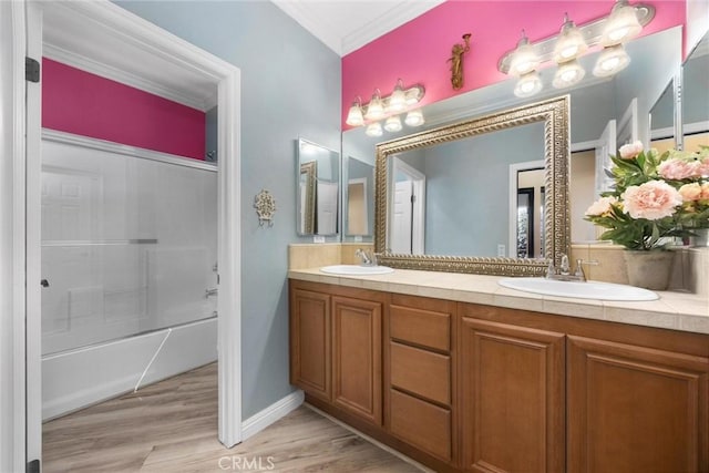 10705 Topiary Dr, Bakersfield, CA 93306 - bathroom featuring double vanity, ornamental molding, wood finished floors, and shower / tub combination