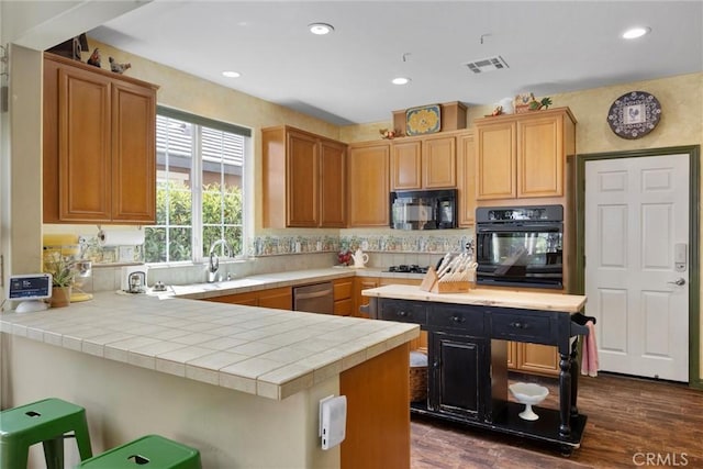 10705 Topiary Dr, Bakersfield, CA 93306 - kitchen featuring black appliances, dark wood finished floors, a peninsula, recessed lighting, and backsplash