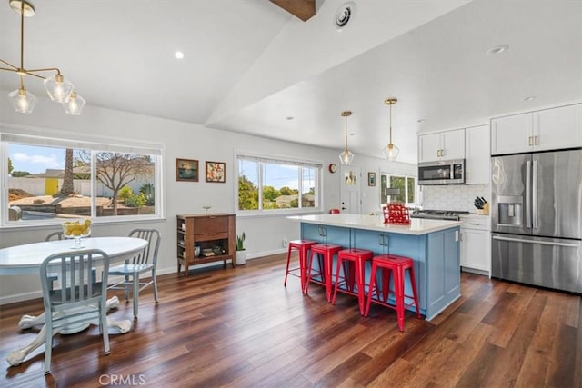 1620 Alrita St, San Luis Obispo, CA 93401 - kitchen featuring appliances with stainless steel finishes, lofted ceiling, dark wood-style floors, light countertops, and white cabinetry