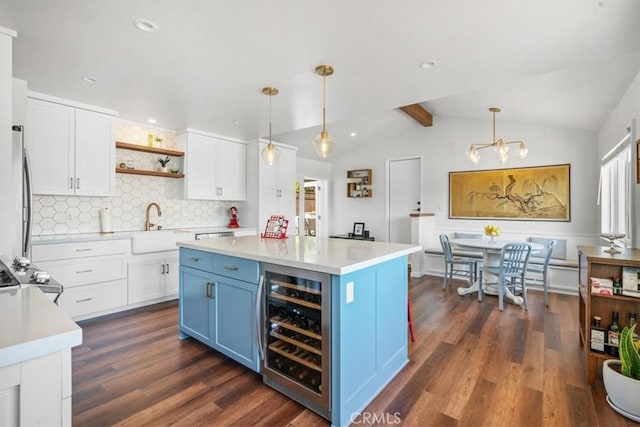 1620 Alrita St, San Luis Obispo, CA 93401 - kitchen featuring wine cooler, blue cabinets, decorative backsplash, white cabinetry, and open shelves