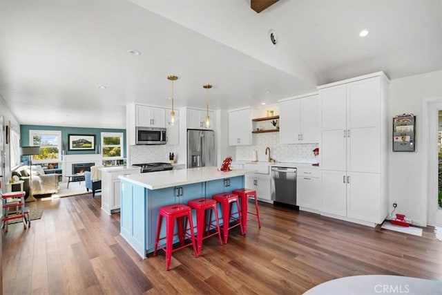 1620 Alrita St, San Luis Obispo, CA 93401 - kitchen featuring stainless steel appliances, open shelves, white cabinets, a center island, and dark wood-type flooring
