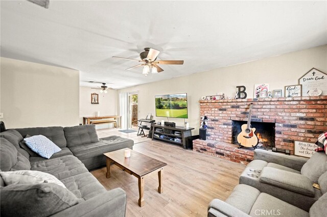 27636 Ethanac Rd, Menifee, CA 92585 - living room with wood finished floors, a ceiling fan, and a brick fireplace