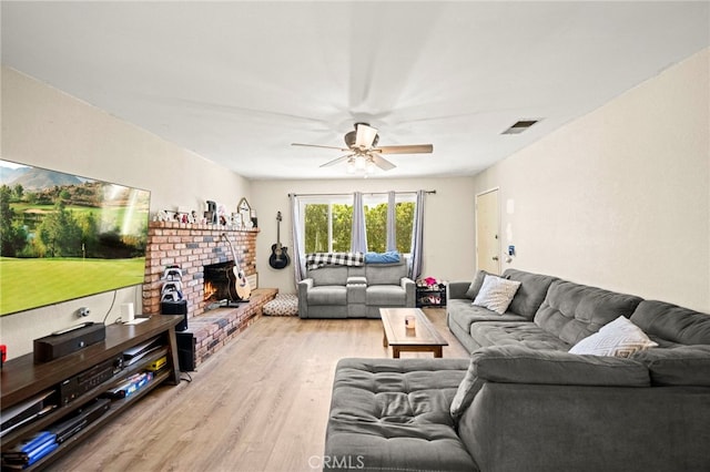 27636 Ethanac Rd, Menifee, CA 92585 - living room featuring wood finished floors, a ceiling fan, and a fireplace