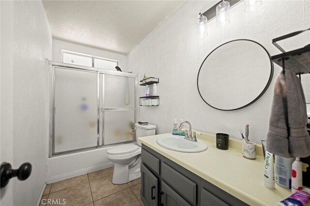 27636 Ethanac Rd, Menifee, CA 92585 - bathroom with vanity, shower / bath combination with glass door, tile patterned flooring, a textured ceiling, and a textured wall