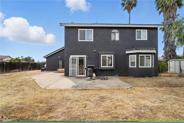13905 Caspian Way, Moreno Valley, CA 92553 - back of property with stucco siding, a fenced backyard, and a patio