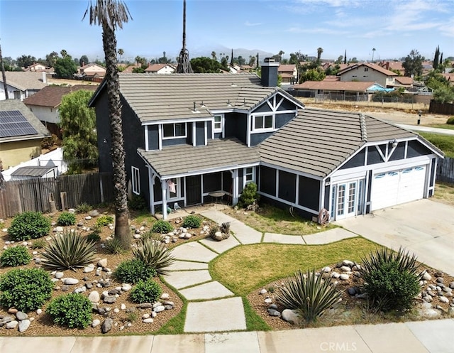 13905 Caspian Way, Moreno Valley, CA 92553 - view of front of property featuring a tiled roof, a residential view, a chimney, and concrete driveway