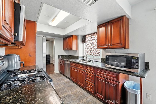 13905 Caspian Way, Moreno Valley, CA 92553 - kitchen featuring stainless steel appliances, a tray ceiling, and light tile patterned floors
