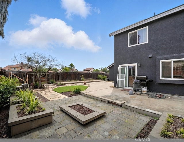 13905 Caspian Way, Moreno Valley, CA 92553 - fenced backyard featuring a patio, a grill, and an outdoor fire pit