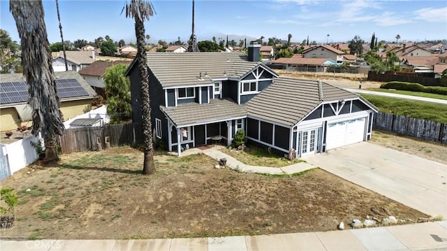 13905 Caspian Way, Moreno Valley, CA 92553 - traditional-style home with a residential view, a tile roof, an attached garage, and concrete driveway