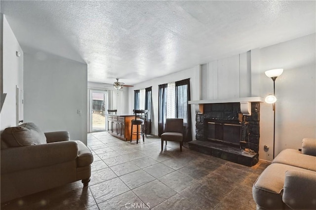13905 Caspian Way, Moreno Valley, CA 92553 - living room featuring a textured ceiling, a ceiling fan, and a stone fireplace