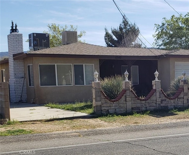 5342 W W Ave L8, Lancaster, CA 93536 - view of front of house featuring stucco siding, roof with shingles, and a chimney