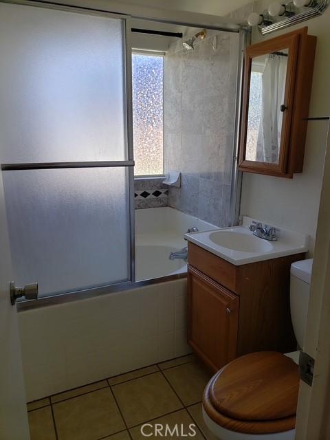 5342 W W Ave L8, Lancaster, CA 93536 - full bathroom with bath / shower combo with glass door, vanity, and tile patterned flooring