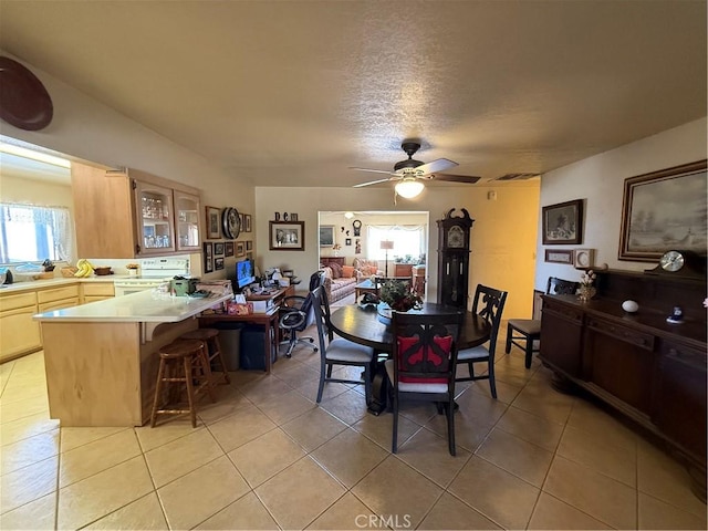59663 Sunway Dr, Yucca Valley, CA 92284 - dining room featuring a ceiling fan, light tile patterned floors, and a textured ceiling