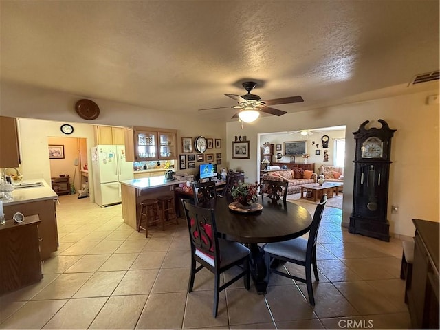 59663 Sunway Dr, Yucca Valley, CA 92284 - dining room featuring light tile patterned floors, ceiling fan, and a textured ceiling