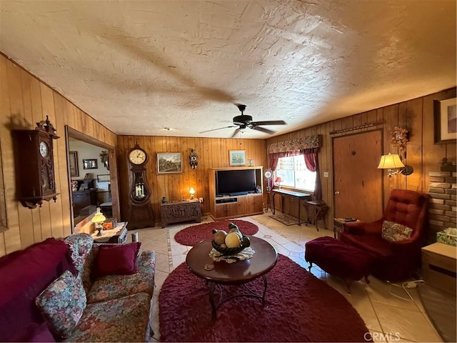 59663 Sunway Dr, Yucca Valley, CA 92284 - living room with wood walls, ceiling fan, light tile patterned floors, and a textured ceiling