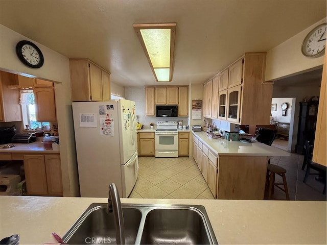 59663 Sunway Dr, Yucca Valley, CA 92284 - kitchen featuring white appliances, light brown cabinets, light countertops, light tile patterned flooring, and a peninsula