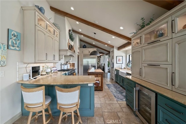 8300 San Diego Rd, Atascadero, CA 93422 - kitchen with wine cooler, stone tile flooring, a peninsula, recessed lighting, and cream cabinets