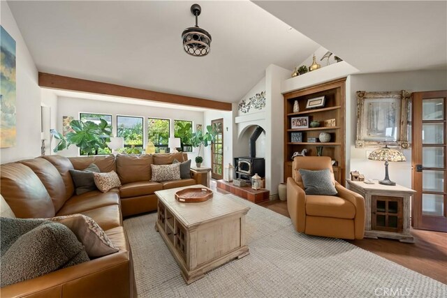 8300 San Diego Rd, Atascadero, CA 93422 - living room featuring a wood stove, light wood-style flooring, and vaulted ceiling