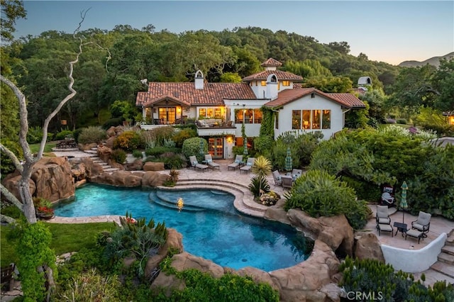 8300 San Diego Rd, Atascadero, CA 93422 - back of property with a patio area, a tile roof, an outdoor pool, stucco siding, and a chimney