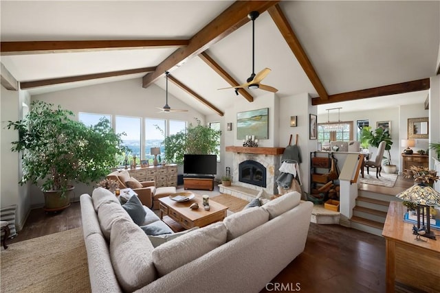 8300 San Diego Rd, Atascadero, CA 93422 - living room featuring wood finished floors, beamed ceiling, a ceiling fan, a glass covered fireplace, and high vaulted ceiling