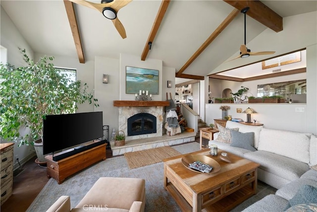 8300 San Diego Rd, Atascadero, CA 93422 - living room featuring ceiling fan, a glass covered fireplace, beamed ceiling, and high vaulted ceiling
