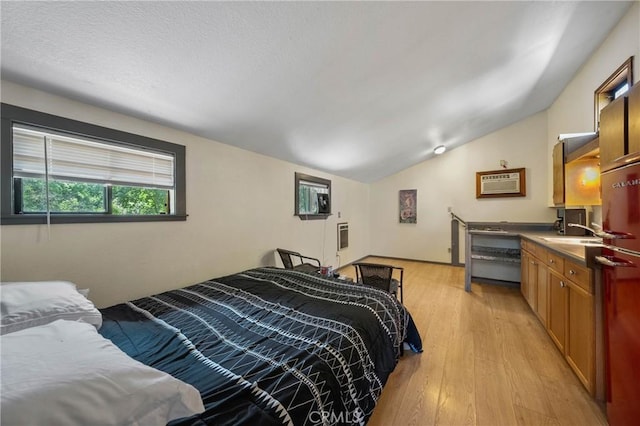 8201 W W Side Potter Valley Rd, Potter Valley, CA 95469 - bedroom featuring lofted ceiling, light wood finished floors, a wall mounted air conditioner, and heating unit