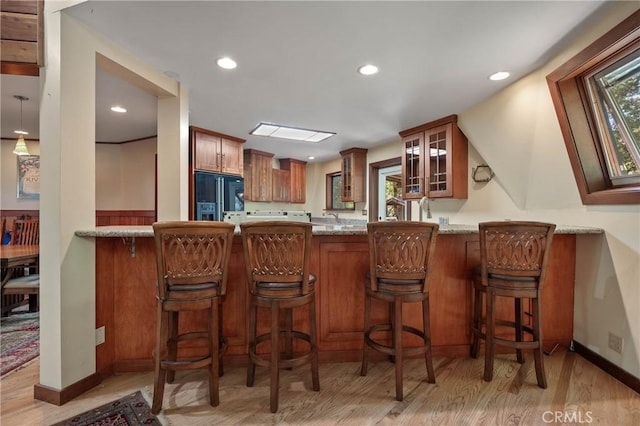 8201 W W Side Potter Valley Rd, Potter Valley, CA 95469 - kitchen featuring high end black refrigerator, light wood-style floors, glass insert cabinets, a peninsula, and recessed lighting