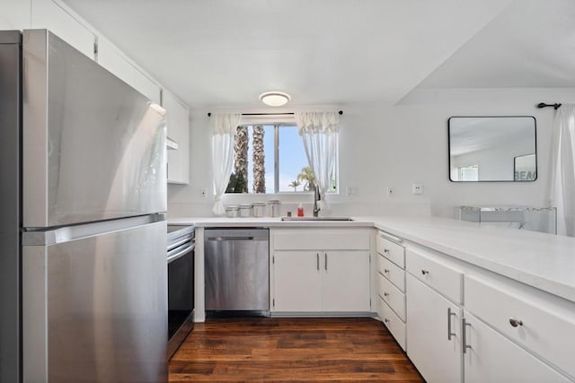 155 Rosebay Dr Unit 31, Encinitas, CA 92024 - kitchen featuring appliances with stainless steel finishes, light countertops, dark wood finished floors, and white cabinetry