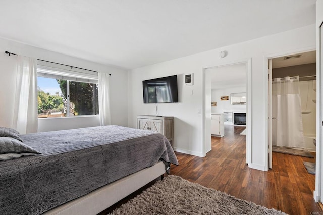 155 Rosebay Dr Unit 31, Encinitas, CA 92024 - bedroom with dark wood-style floors and a fireplace