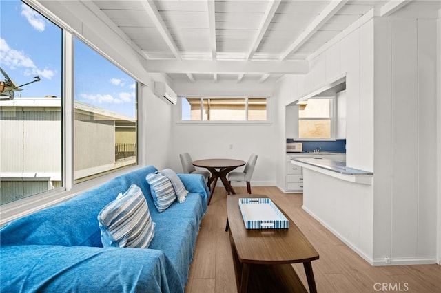 1924 W Oceanfront, Newport Beach, CA 92663 - living room with light wood finished floors, a wall mounted air conditioner, and beamed ceiling