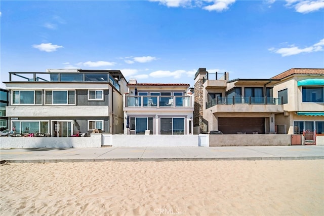 1924 W Oceanfront, Newport Beach, CA 92663 - back of property with a balcony, a chimney, and stucco siding