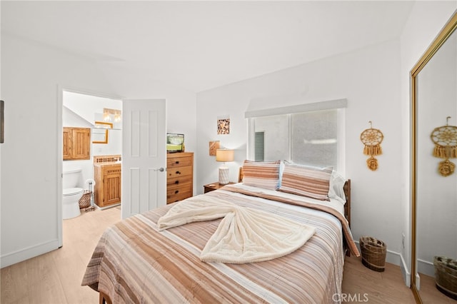 1924 W Oceanfront, Newport Beach, CA 92663 - bedroom with light wood finished floors, connected bathroom, a closet, and vaulted ceiling