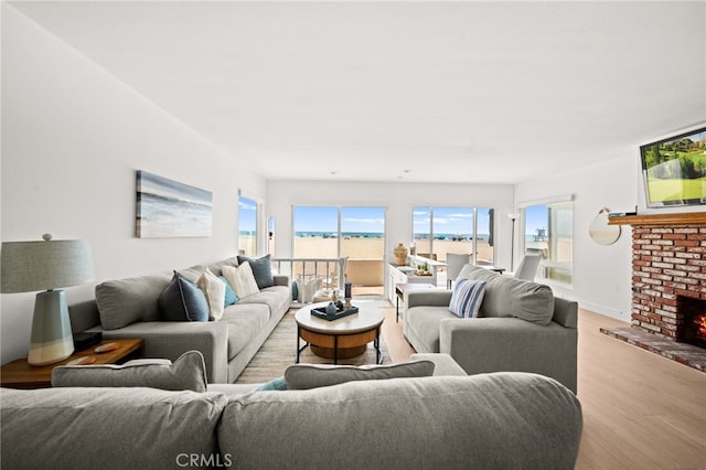 1924 W Oceanfront, Newport Beach, CA 92663 - living area with wood finished floors and a brick fireplace