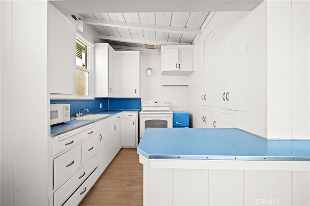 1924 W Oceanfront, Newport Beach, CA 92663 - kitchen with white appliances, light wood-style flooring, white cabinetry, and a wooden ceiling with exposed beams