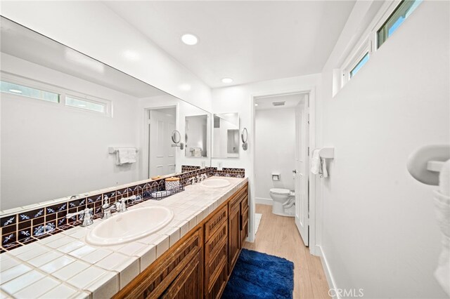 1924 W Oceanfront, Newport Beach, CA 92663 - bathroom with double vanity, wood finished floors, and recessed lighting