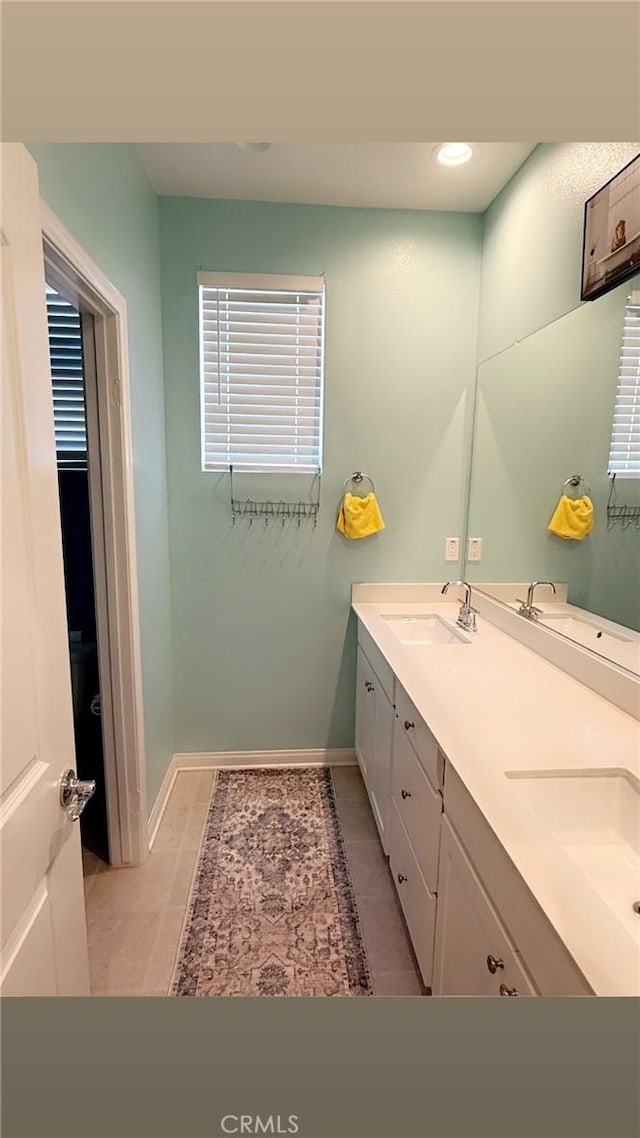 16009 Pitzer St, Fontana, CA 92336 - full bath featuring double vanity, tile patterned floors, and recessed lighting