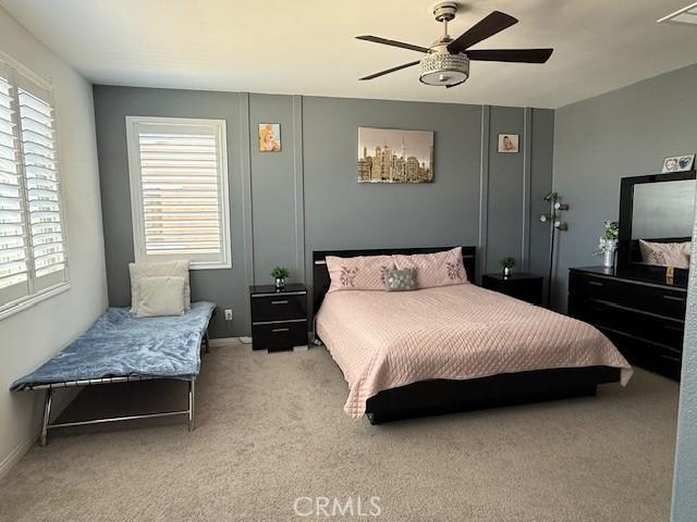 16009 Pitzer St, Fontana, CA 92336 - carpeted bedroom with multiple windows and ceiling fan