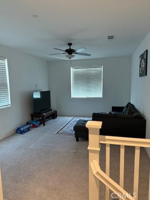 16009 Pitzer St, Fontana, CA 92336 - carpeted living area featuring a ceiling fan