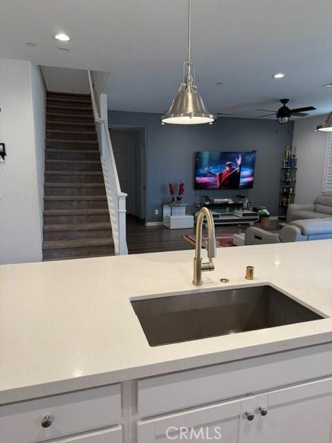 16009 Pitzer St, Fontana, CA 92336 - kitchen featuring light countertops, white cabinetry, open floor plan, a ceiling fan, and hanging light fixtures
