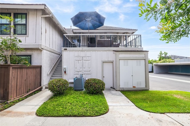 4809 Fieldbrook Ln, Cypress, CA 90630 - view of front facade with board and batten siding, stairway, and a balcony